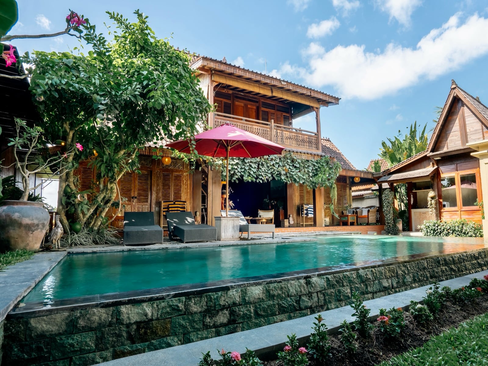 Rumah Elfi: pool and wooden Joglo house in a tropical garden