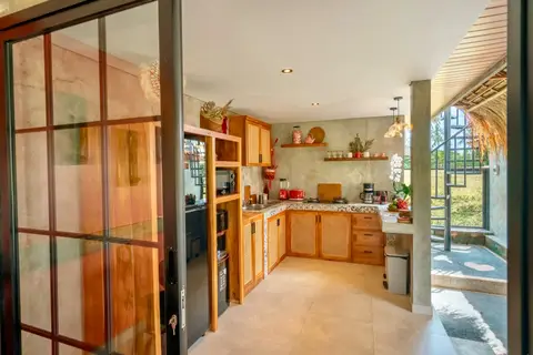 Joglo Hati: kitchen with wooden cabinets