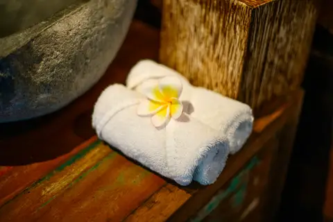 Rumah Richard: rolled towels with a frangipani flower