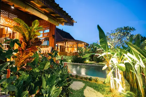 Rumah Richard: lit garden and pool in the evening